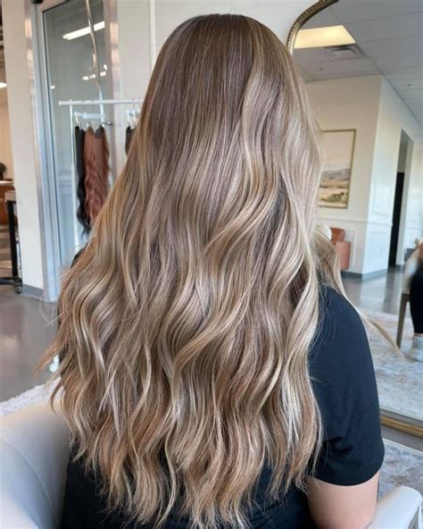 This ear-leveled bob in a dark brown color, cut with blunt cut bangs, has a softer look thanks to the platinum blonde highlights applied evenly . . Light brown hair with blonde highlights